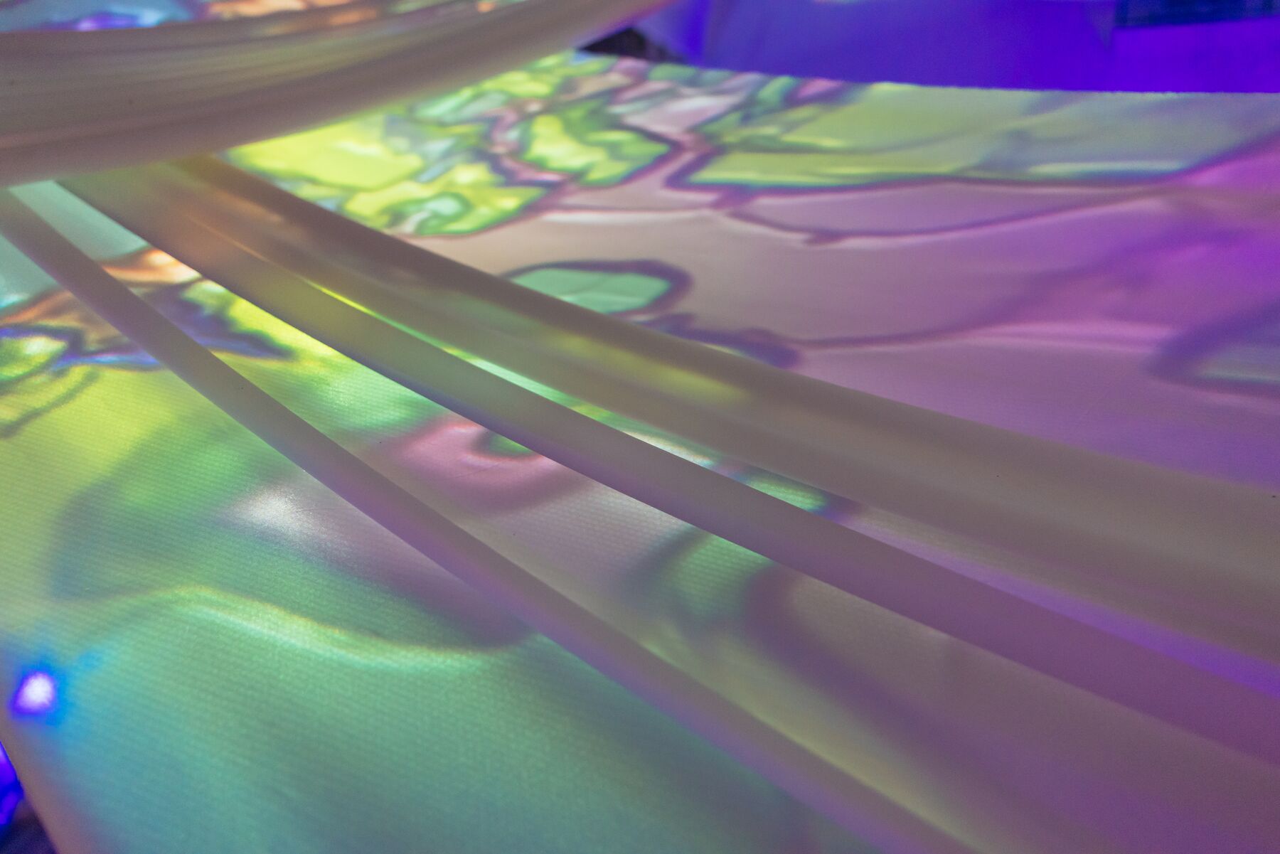 Detail of the drapes above the octagon, projection light in green and violet.
